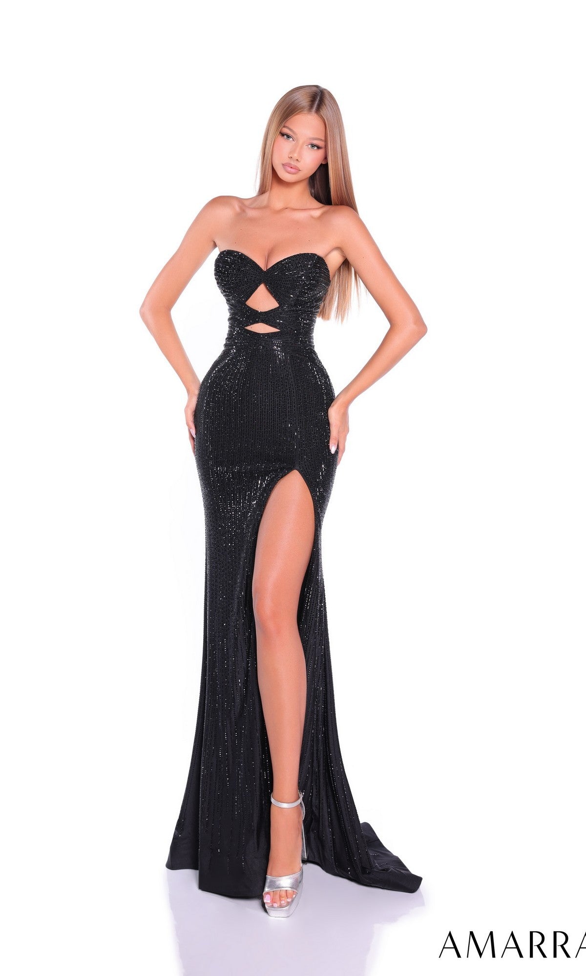 A woman poses against a white background in the Amarra 89080 long prom dress—a strapless, floor-length black gown with a sweetheart neckline, waist cut-outs, and a high leg slit.